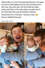 down syndrome man holds brother's baby.jpg